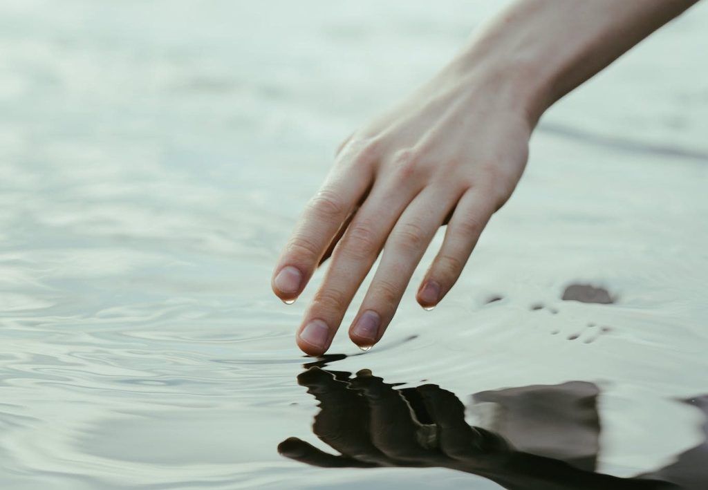 A Person Touching the Water Surface