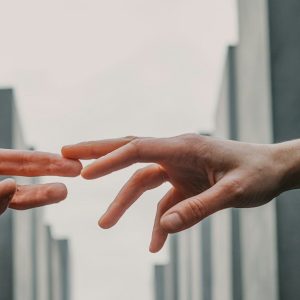 two person touching each others finger tips